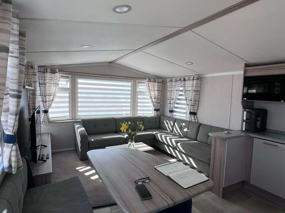 Striped night and day blinds fitted in a holiday-home lounge