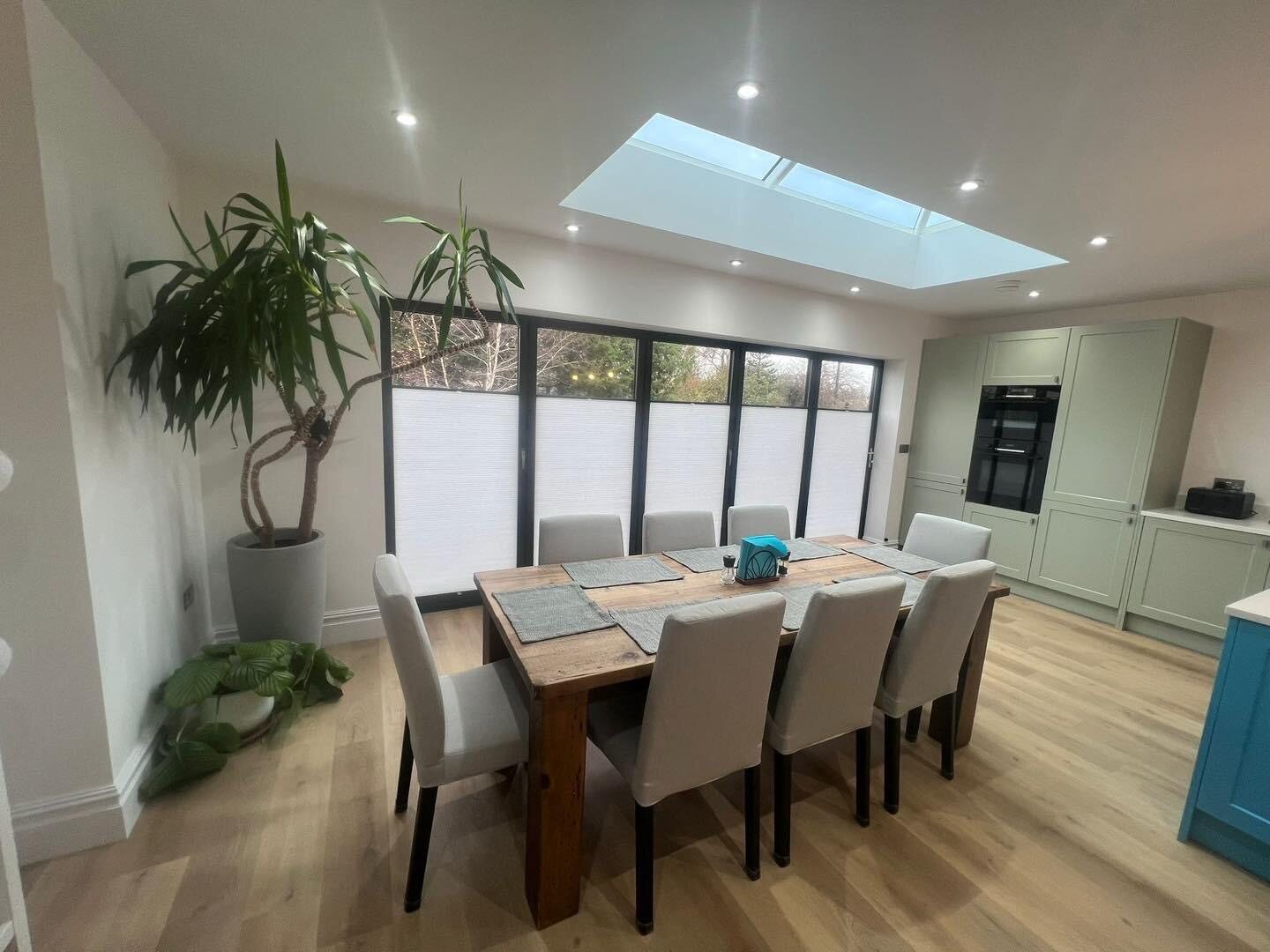 White pleated Perfect Fit blinds fitted to black bi-fold doors
