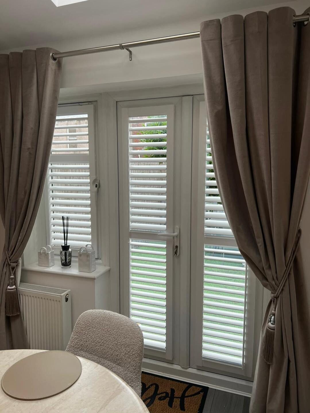 White plantation shutters fitted to glazed French doors