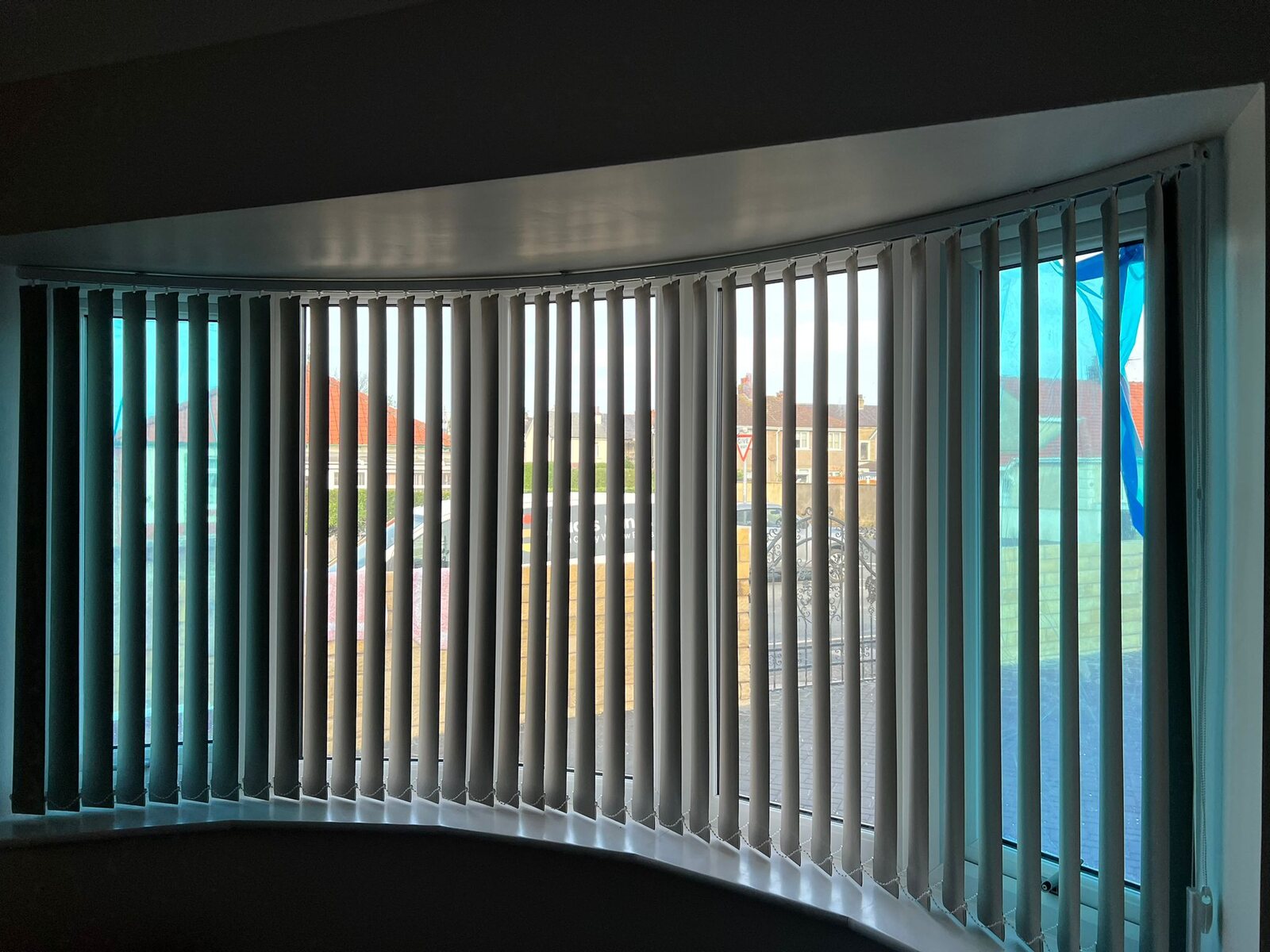 Vertical blinds fitted across a wide window