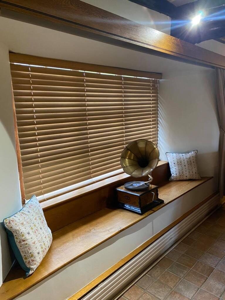 Wooden Venetian blinds fitted at a residential window